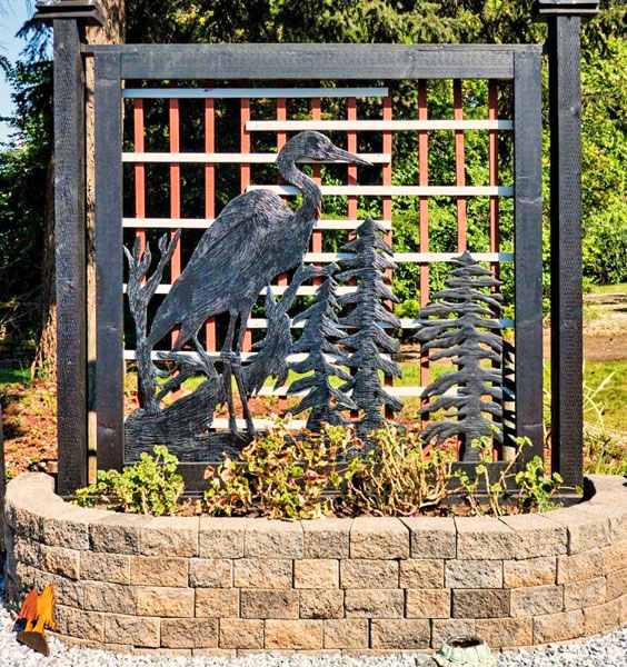 garden privacy fence of heron on trees by Vancouver Island wood carver West Coast Wood Creations